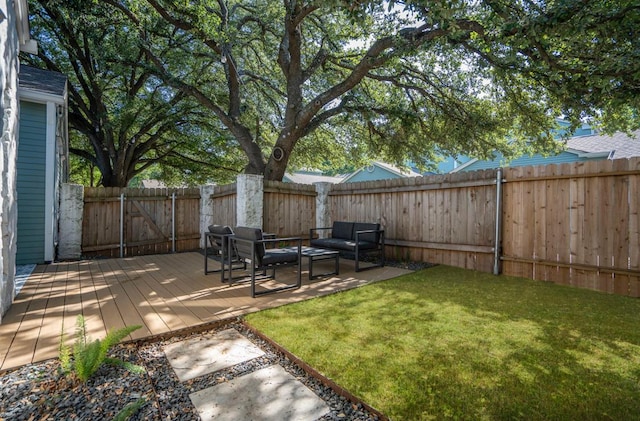 view of yard featuring a fenced backyard, a deck, and an outdoor hangout area