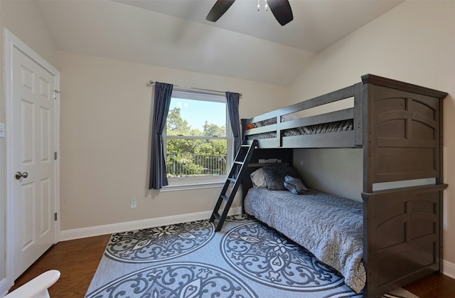 bedroom with lofted ceiling, wood finished floors, a ceiling fan, and baseboards