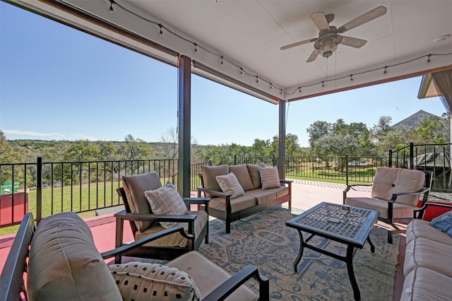 view of patio with a ceiling fan, fence, and an outdoor living space