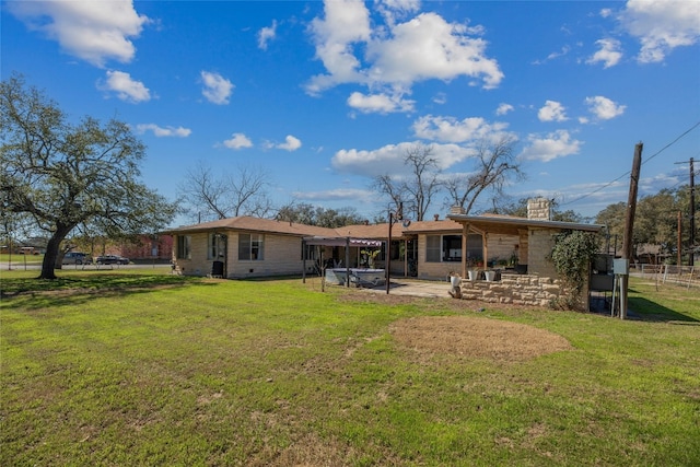 back of property featuring a chimney, a lawn, a patio area, and fence