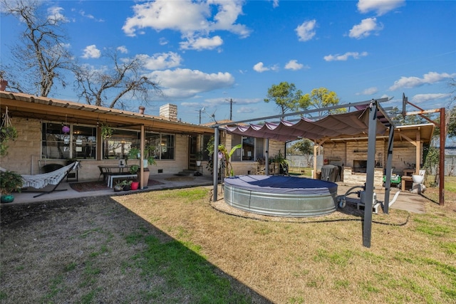 view of yard featuring a patio, a swimming pool, and a pergola