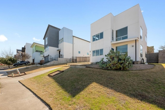 view of property's community featuring a yard and fence