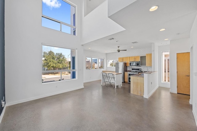 interior space featuring stainless steel appliances, recessed lighting, light countertops, visible vents, and baseboards