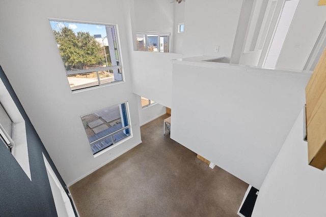 staircase featuring heating unit and a high ceiling