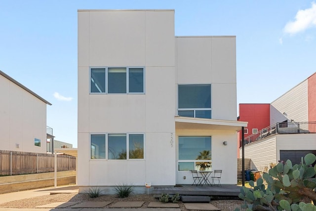 view of front of house featuring fence and stucco siding