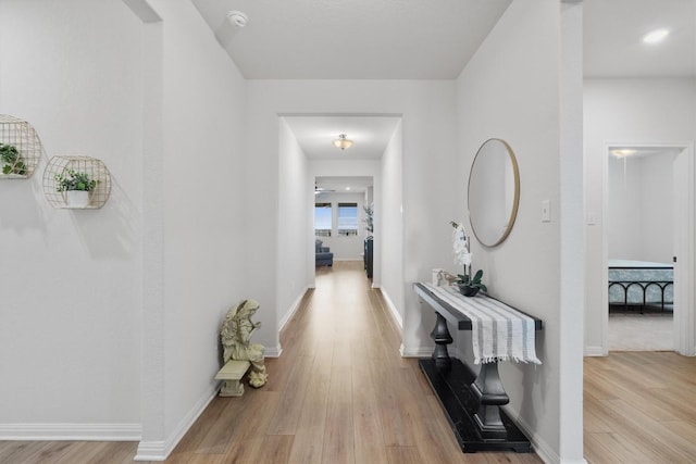 3008 Ottaviano Way, Hutto, TX 78634 - hall with light wood-style flooring and baseboards