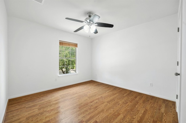 unfurnished room featuring a ceiling fan, baseboards, and wood finished floors