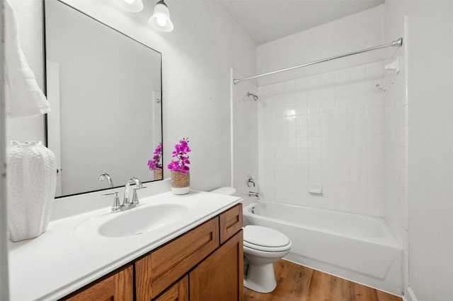 full bath with tub / shower combination, vanity, toilet, and wood finished floors