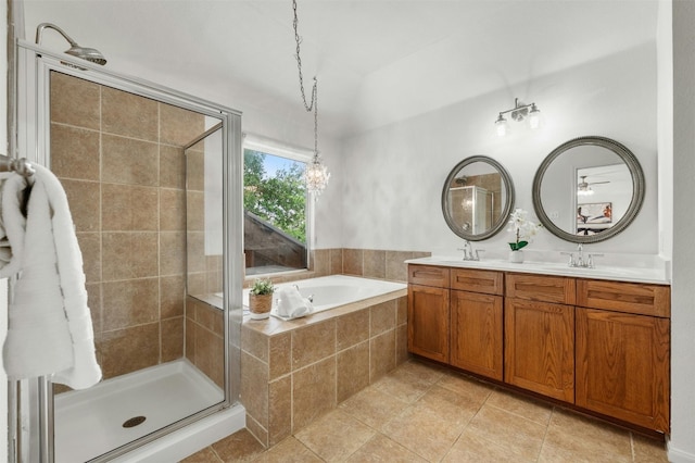 bathroom with double vanity, a stall shower, a sink, and a bath