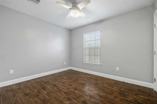 spare room featuring ceiling fan, baseboards, visible vents, and dark wood finished floors