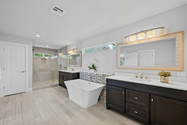 full bathroom with a stall shower, a sink, visible vents, and a healthy amount of sunlight