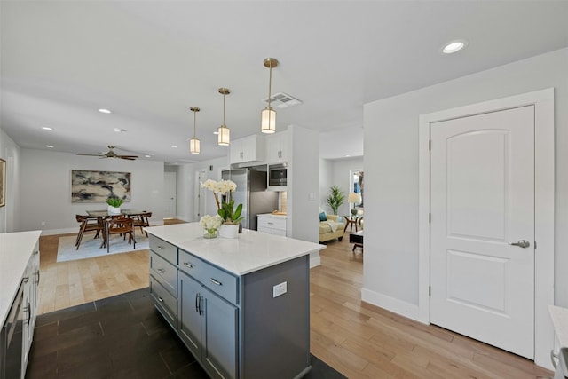 kitchen with dark wood-style floors, stainless steel appliances, recessed lighting, gray cabinets, and light countertops