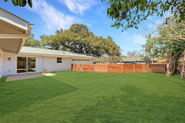 view of yard featuring fence and a patio