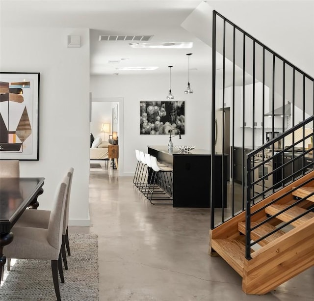 stairway with concrete flooring, visible vents, and baseboards