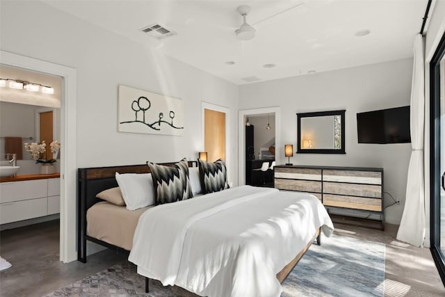 bedroom featuring concrete flooring, ensuite bathroom, visible vents, and a ceiling fan