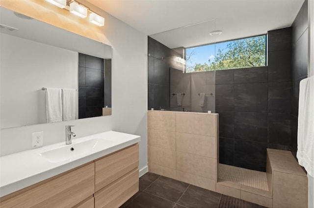 bathroom with tile patterned flooring, visible vents, a walk in shower, and vanity