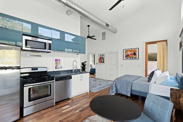 kitchen featuring visible vents, a ceiling fan, dark countertops, open floor plan, and stainless steel appliances