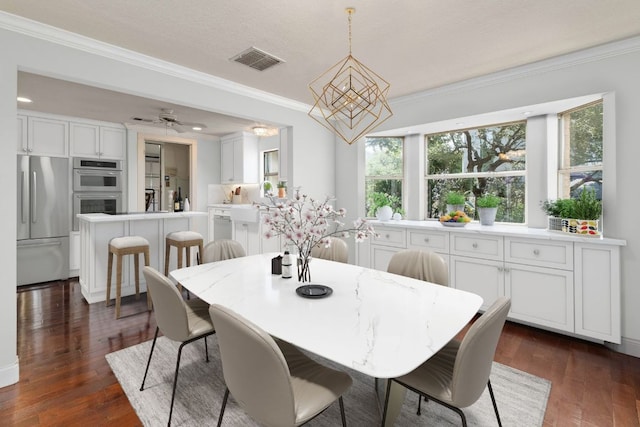 dining area with visible vents, dark wood-type flooring, and crown molding