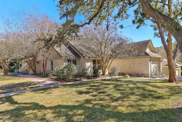 view of front of house with a garage, stone siding, and a front yard