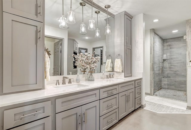 bathroom featuring double vanity, recessed lighting, a sink, and a shower stall