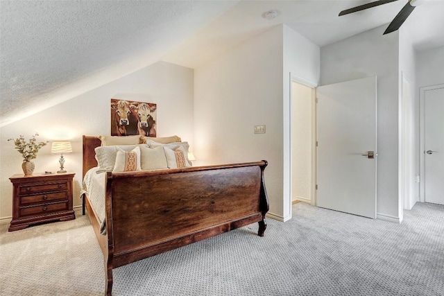 bedroom featuring a textured ceiling, light carpet, a ceiling fan, baseboards, and vaulted ceiling