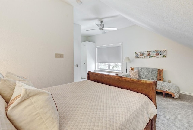 carpeted bedroom with a ceiling fan, lofted ceiling, and a textured ceiling