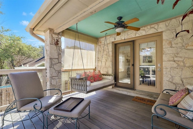 wooden terrace with a ceiling fan