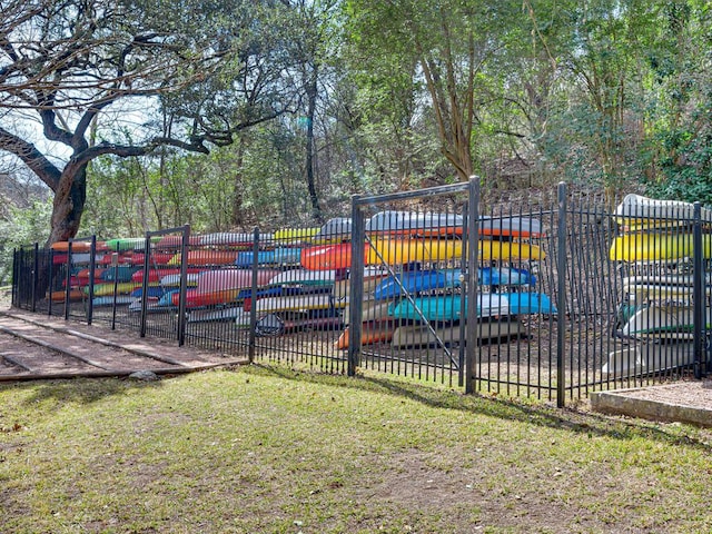 exterior space featuring fence and a lawn