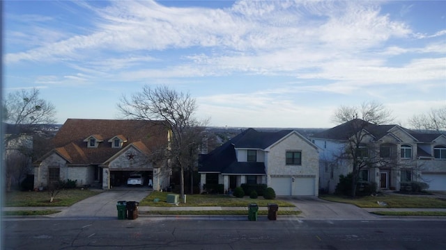 view of front of property featuring a residential view, stone siding, and driveway