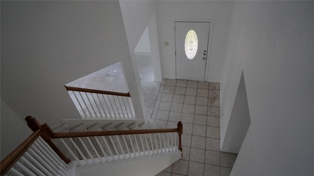 staircase featuring tile patterned flooring