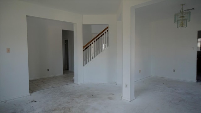 unfurnished room with stairs, concrete floors, a chandelier, and visible vents