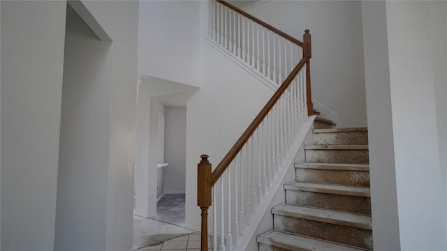 stairs featuring a high ceiling