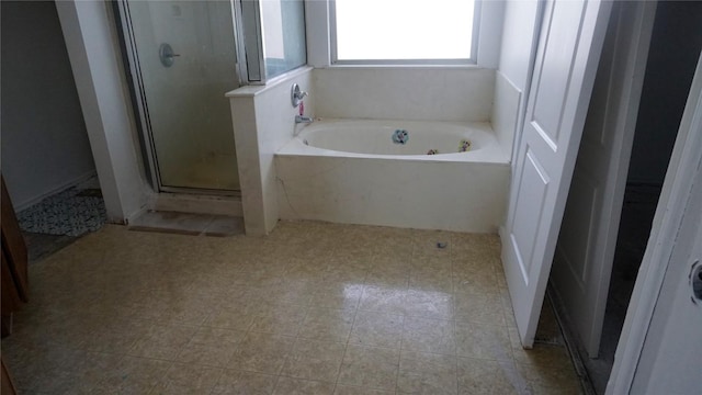 bathroom featuring a shower stall and a bath