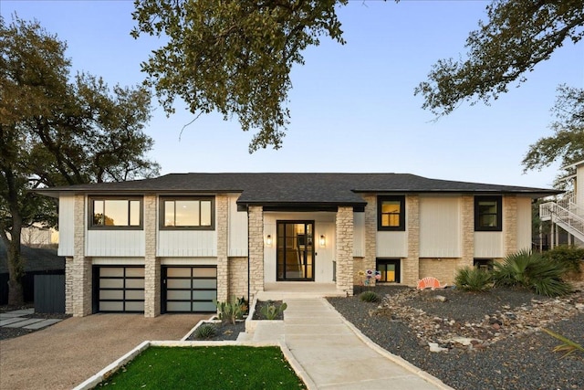 view of front of home featuring a garage, stone siding, aphalt driveway, and roof with shingles