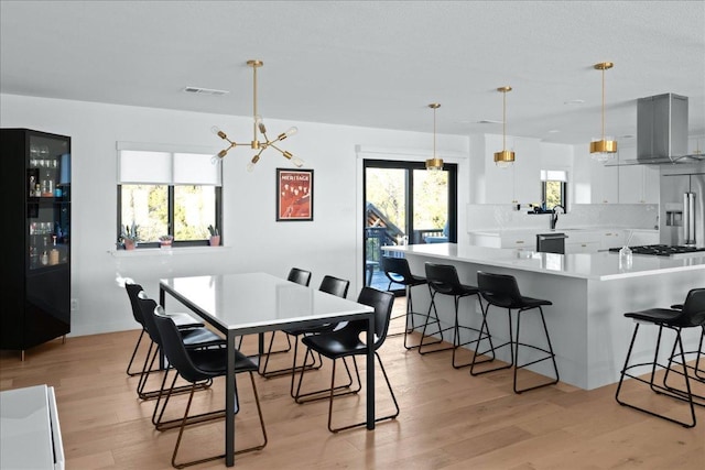 4200 Bluffridge Dr, Austin, TX 78759 - dining space with light wood-type flooring and a chandelier