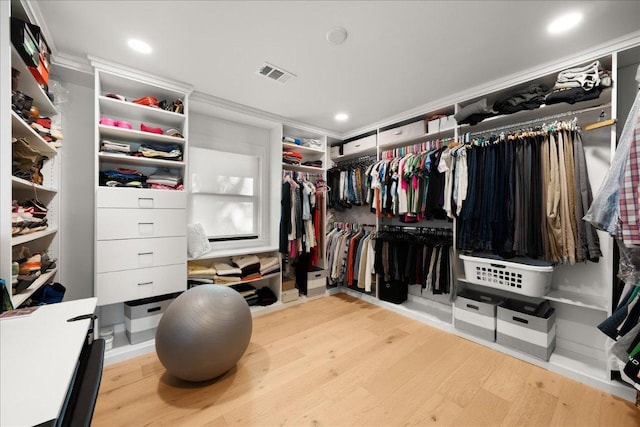 walk in closet with wood finished floors and visible vents