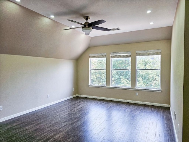 bonus room with dark wood-type flooring, ceiling fan, lofted ceiling, baseboards, and a textured ceiling