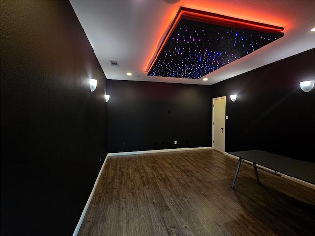 1008 Walsh Hill Trl, Cedar Park, TX 78613 - home theater room with a tray ceiling, wood finished floors, recessed lighting, and baseboards