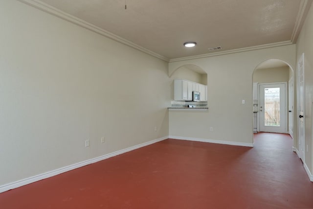 12249 Abbey Glen Ln Unit B, Austin, TX 78753 - unfurnished living room with ornamental molding, arched walkways, and baseboards