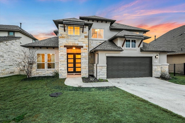 view of front facade featuring driveway, a front yard, fence, and stucco siding