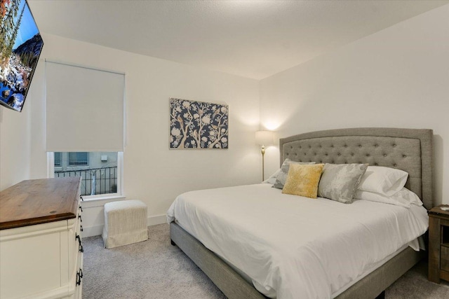 carpeted bedroom featuring baseboards