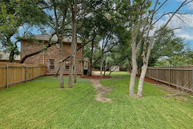 view of yard with a fenced backyard and an outdoor structure