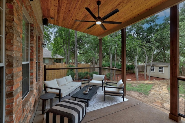 view of patio / terrace with a shed, a fenced backyard, ceiling fan, an outdoor structure, and outdoor lounge area