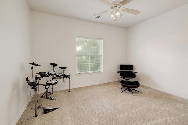 interior space with carpet, ceiling fan, and baseboards