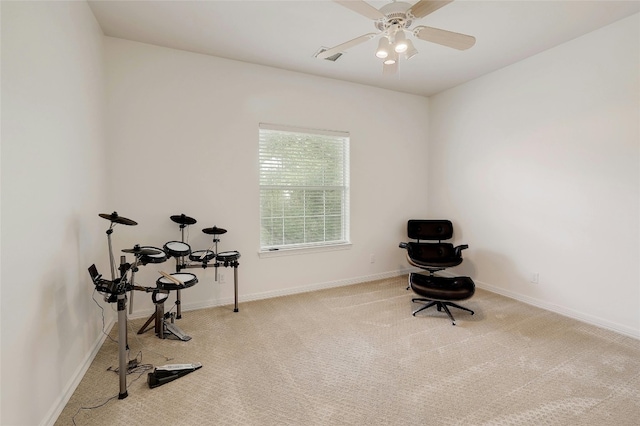 misc room featuring baseboards, a ceiling fan, and carpet flooring