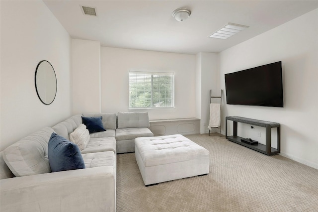 living room featuring carpet, visible vents, and baseboards