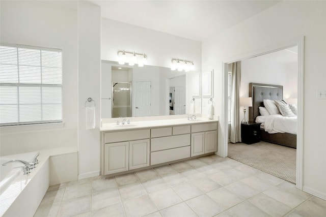full bathroom with a sink, a garden tub, a shower stall, and double vanity