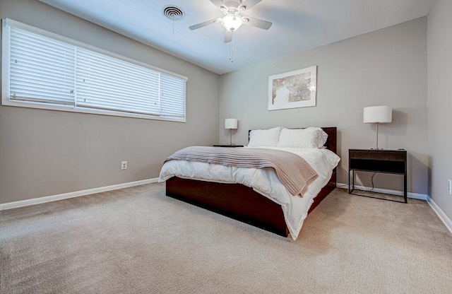 bedroom with ceiling fan, carpet flooring, visible vents, and baseboards