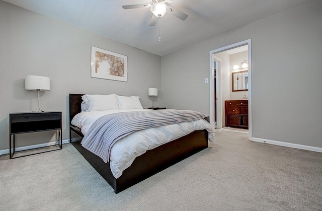 carpeted bedroom featuring connected bathroom, baseboards, and a ceiling fan