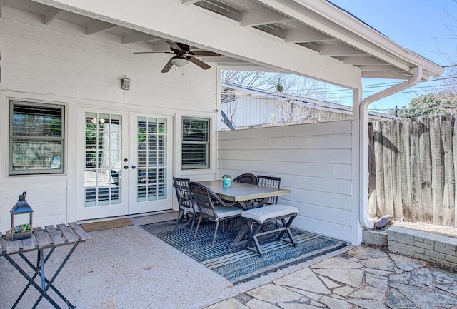 view of patio featuring ceiling fan, french doors, outdoor dining space, and fence